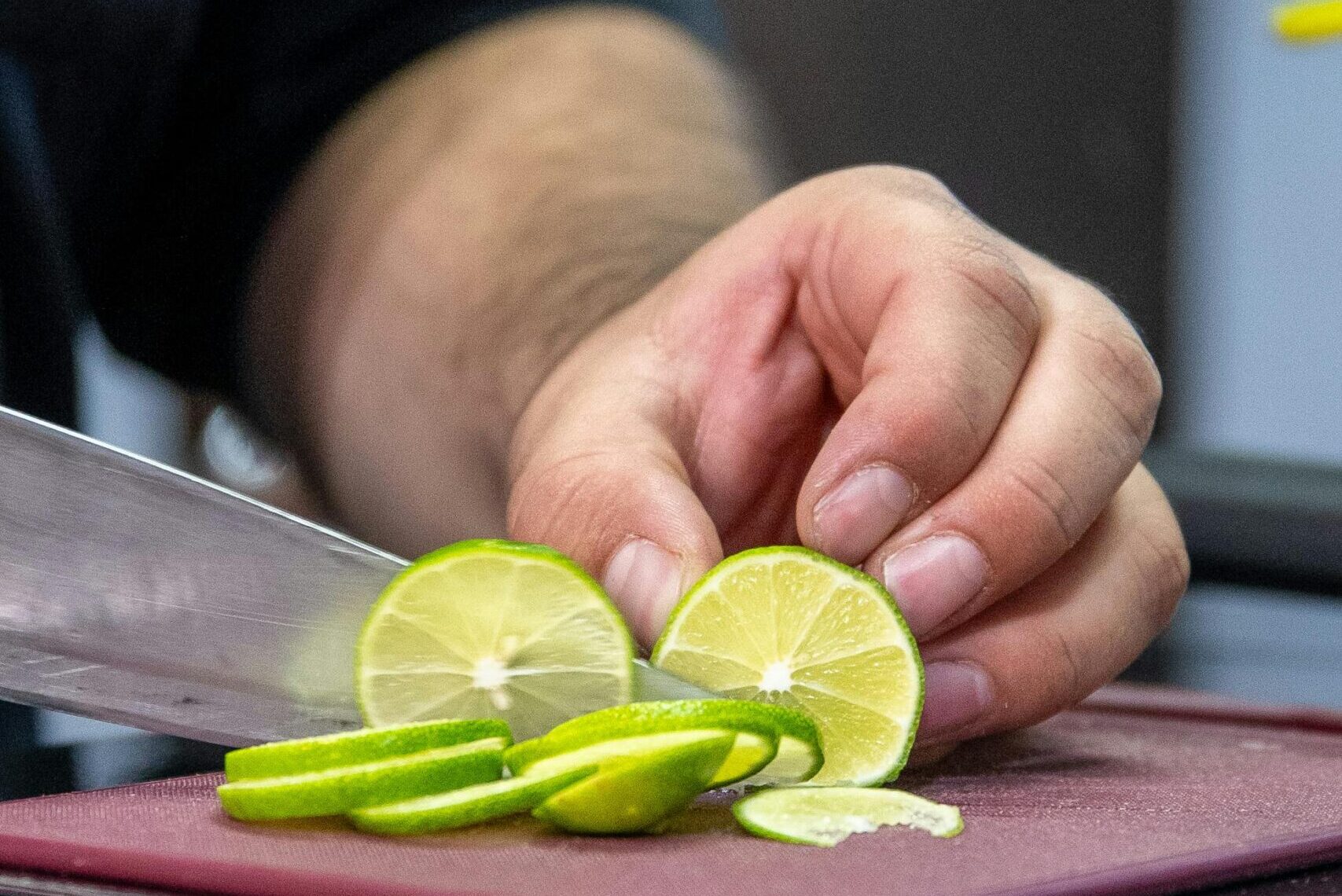 Slicing lime in kitchen Slicing lime in kitchen